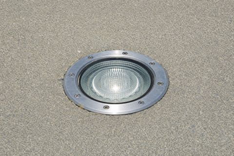 A runway ground light fixture set into pavement.