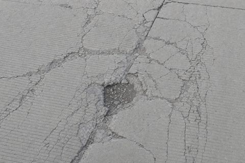 Cracked and spalled runway pavement.