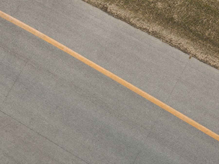Airfield taxiway pavement seen straight from above.