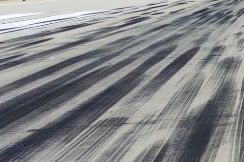 Runway pavement with rubber deposits from repeated tyre contact.